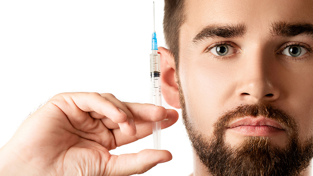 Man holding syringe with steroids